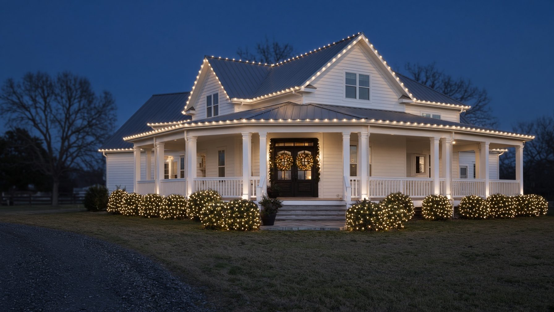 Farmhouse with C9-style holiday lighting on the porch and roof